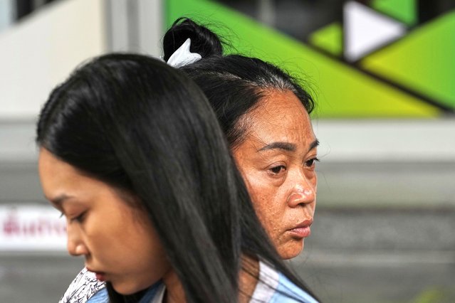 Naruemol Thonglek, right, with her daughter, waits for news of her partner, who is missing after the collapse of an under-construction high-rise building after an earthquake in Bangkok, Thailand, Monday, March, 31, 2025. (Photo by Manish Swarup/AP Photo)