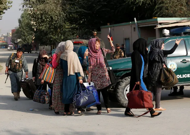 Students walk toward a police vehicle after they were rescued from the site of an attack at the American University of Afghanistan in Kabul, Afghanistan August 25, 2016. (Photo by Mohammad Ismail/Reuters)