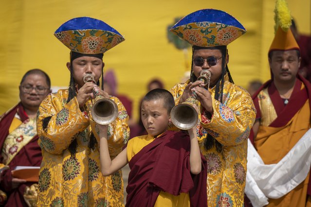 A young monk holds a traditional instrument played by fellow monks during Gyalpo Losar, the Sherpa community's New Year celebration, at Shechen Monastery in Kathmandu, Nepal, on Tuesday, February 25, 2025. (Photo by Niranjan Shrestha/AP Photo)