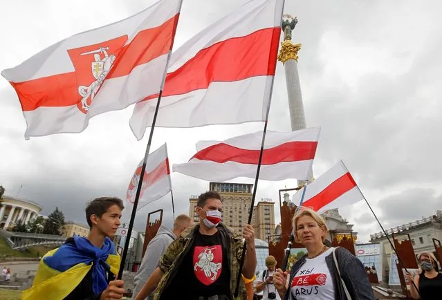 Belarusian activists who living in Ukraine hold Belarusian flags during a rally called “Free Belarus” on the Independence Square in Kyiv, Ukraine, on 01 August, 2020. Belarusian activists held the rally of solidarity with Belarus opposition in the center of Ukrainian capital. The Presidential elections is scheduled in Belarus on 09 August 2020. (Photo by Stringer/NurPhoto via Getty Images)
