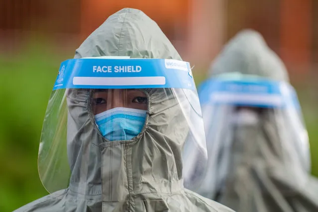 Police personnel wearing protective gear arrives at Pashupati Electric Crematorium during cremation of a person who died of COVID-19 in Kathmandu, Nepal on August 17, 2020. (Photo by Rojan Shrestha/NurPhoto via Getty Images)