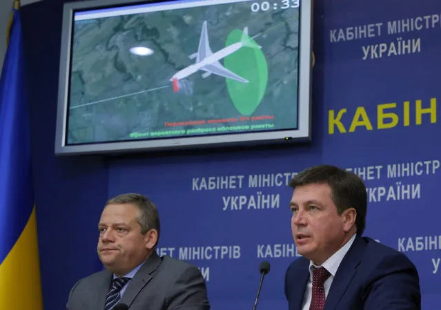 Vice Prime Minister and chairman of the government commission to investigate the causes of the MH17 crash Hennadiy Zubko, right, speaks at a briefing for journalists  in Kiev, Ukraine, Tuesday, October 13, 2015. Investigators said the Buk missile that downed Malaysia Airlines Flight 17 exploded less than a meter from the cockpit, killing the two pilots and the purser inside in an instant and breaking off the front of the plane. (Photo by Sergei Chuzavkov/AP Photo)