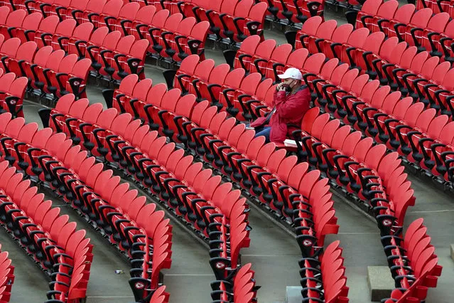 A fan waits in Arrowhead Stadium for the start of an NFL football game between the Kansas City Chiefs and the Houston Texans Thursday, Sept. 10, 2020, in Kansas City, Mo. About 16,000 fans are expected to attend the game. (Photo by Jeff Roberson/AP Photo)