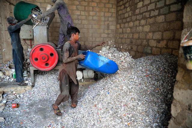 Workers process plastic waste to be recycled in Hyderabad, Pakistan, 04 June 2025. This year World Environmental Day, celebrated on 05 June, will focus on reducing plastic pollution. (Photo by Nadeem Khawer/EPA)