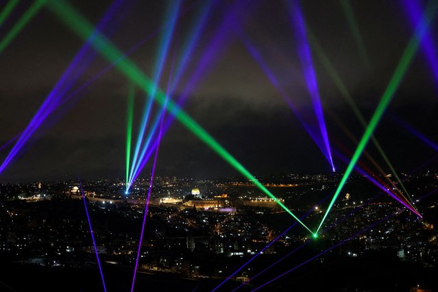 Colourful lasers illuminate the sky above Jerusalem as part of a display longing for peace and harmony, amid the ongoing conflict in Gaza between Israel and Hamas, in Jerusalem on March 18, 2024. (Photo by Ronen Zvulun/Reuters)