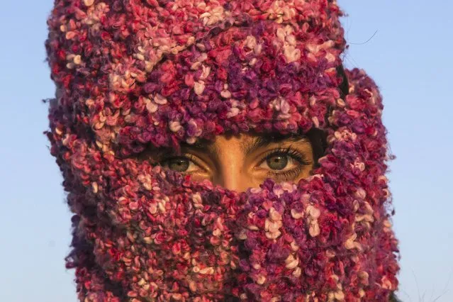 A woman from Syria looks on as she waits to cross the border with Croatia near the village of Berkasovo, Serbia, October 21, 2015. (Photo by Marko Djurica/Reuters)