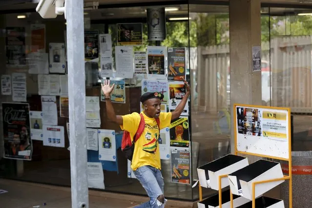 A student reacts during their confrontation with security guards as they protest over planned increases in tuition fees outside the (UJ) University of Johannesburg, October 22, 2015. South Africa's President Jacob Zuma said on Thursday he will meet student leaders and university authorities on Friday to discuss planned hikes in tuition fees that have sparked a week of nationwide protests, some of which have turned violent. (Photo by Siphiwe Sibeko/Reuters)