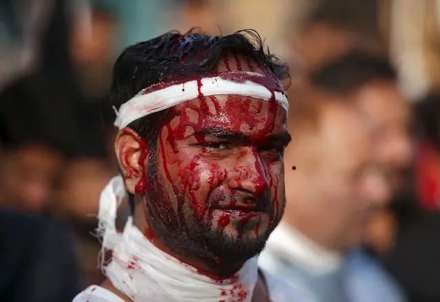 A Shi'ite Muslim mourner looks on after flagellating himself during a Muharram procession ahead of Ashura in Srinagar, October 23, 2015. Ashura, which falls on the 10th day of the Islamic month of Muharram, commemorates the death of Imam Hussein, grandson of Prophet Mohammad, who was killed in the 7th century battle of Kerbala. (Photo by Danish Ismail/Reuters)