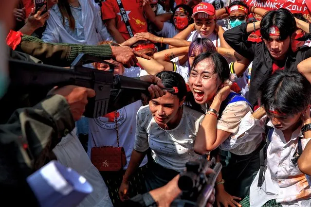 Protesters perform during a demonstration to mark the second anniversary of Myanmar's 2021 military coup, outside the Embassy of Myanmar in Bangkok, Thailand on February 1, 2023. (Photo by Athit Perawongmetha/Reuters)