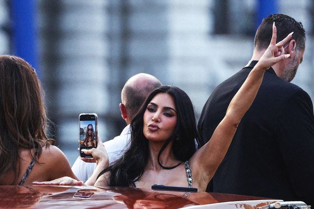 Kim Kardashian gestures on a boat ahead of the anticipated wedding of Amazon founder Jeff Bezos and journalist Lauren Sanchez in Venice, Italy, on June 26, 2025. (Photo by Guglielmo Mangiapane/Reuters)