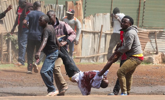 Protesters carry a casualty during the “Saba Saba People's March” anti-government protest in Nairobi, Kenya on July 7, 2025. (Photo by Monicah Mwangi/Reuters)