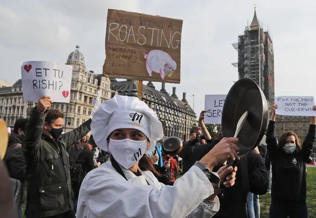 Hospitality workers protest in Parliament Square in London, Monday, October 19, 2020. Hospitality workers are demonstrating outside Parliament against tougher coronavirus restrictions and the amount of financial support given by the government to the industry. (Photo by Frank Augstein/AP Photo)