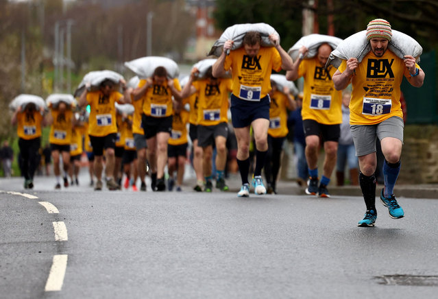 Male competitors race during the World Coal Carrying Championships in Gawthorpe, Britain, on April 1, 2024. (Photo by Lee Smith/Reuters)