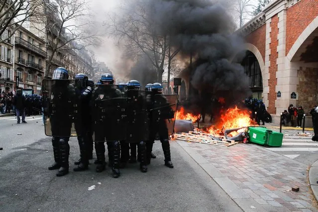 Police prepare to charge protesters during a new demonstration day against the government's reform of the pension system in Paris, France, 11 March 2023. Protests continue across the country due to the French government's plan to delay the minimum retirement age from 62 to 64 by 2030. On 09 March, a majority of senators validated the postponement of the legal retirement age to 64 years. If they agree on a text, the final adoption of the reform could take place on 16 March. (Photo by Teresa Suarez/EPA)