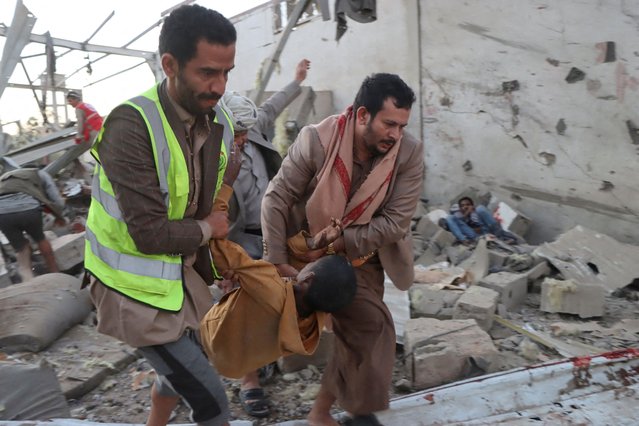 Rescuers carry an injured African migrant after a strike hit a detention centre hosting African migrants, in Saada, Yemen on April 28, 2025. (Photo by Naif Rahma/Reuters)