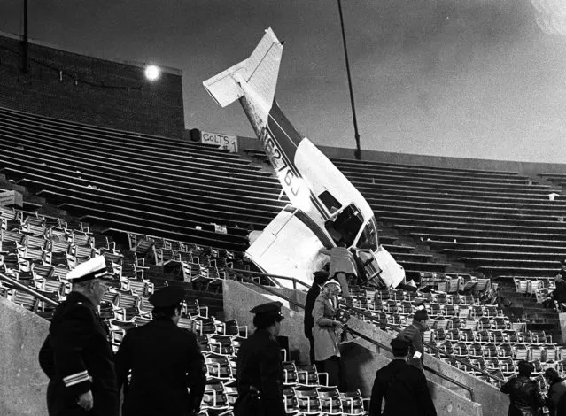 A plane sits in the upper deck of Baltimore's Memorial Stadium after crashing into the stands, on December 19, 1976, during a game between the Baltimore Colts and the Pittsburgh Steelers. (Photo by AP Photo)