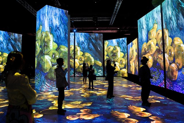 People visit “Van Gogh: The Immersive Experience”, a multi-sensorial exhibition featuring artworks of renowned artist Vincent van Gogh at a department store in Bangkok, Thailand on March 30, 2023. (Photo by Chalinee Thirasupa/Reuters)