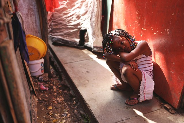 A child sits in a walkway at a shelter for families displaced by gang violence, in Port-au-Prince, Haiti, Thursday, May 22, 2025. (Photo by Odelyn Joseph/AP Photo)