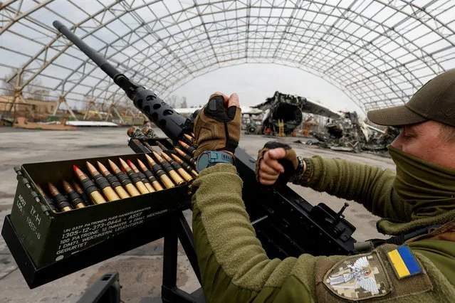 A member of the mobile air defence group checks a M2 Browning machine gun atop of a pick up truck donated by volunteer fund during a handover ceremony, amid Russia's attack on Ukraine, in the town of Hostomel, Kyiv region, Ukraine on April 1, 2023. (Photo by Valentyn Ogirenko/Reuters)