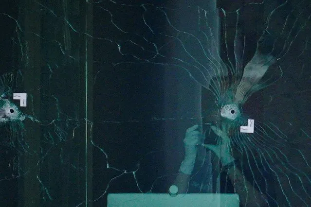 Investigators inspect bullet holes at the scene of a mass shooting at Old National Bank in downtown Louisville, Kentucky, U.S. April, 10, 2023. (Photo by Jeffrey Dean/Reuters)