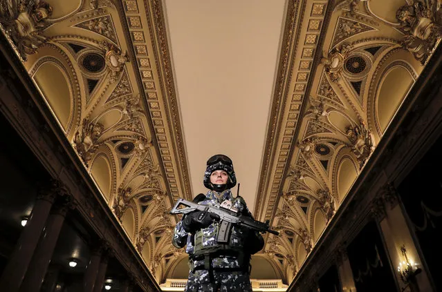 A woman in the Romanian armed forces models a future Romanian military combat uniform, at the Central Army House in Bucharest, Romania, Tuesday, October 25, 2016. Romania celebrates Army Day which marks Romania liberation of the Nazi occupation in 1944. (Photo by Vadim Ghirda/AP Photo)