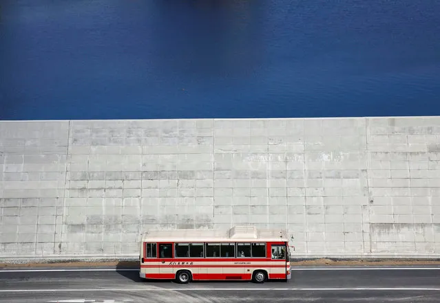 A bus is driven past a seawall in Yamada village, Iwate Prefecture, Japan, March 3, 2018. (Photo by Kim Kyung-Hoon/Reuters)