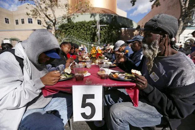An early Thanksgiving meal is served to the homeless at the Los Angeles Mission in Los Angeles, California, November 25, 2015. (Photo by Mario Anzuoni/Reuters)