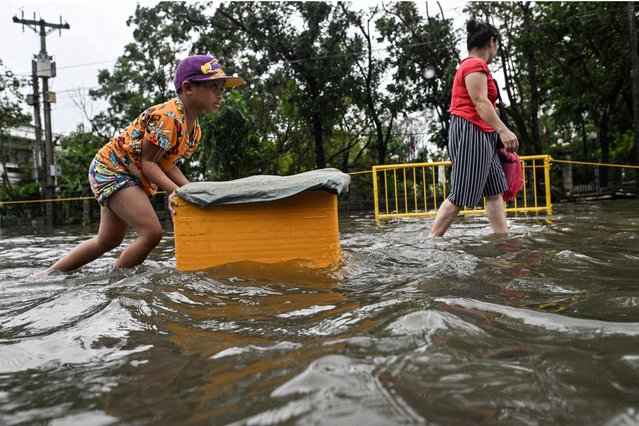 A boy pushes a styrofoam box as he wades through a flooded street after Typhoon Fung-wong hit Dagupan City, Pangasinan, Philippines, on November 10, 2025. (Photo by Noel Celisn/Reuters)