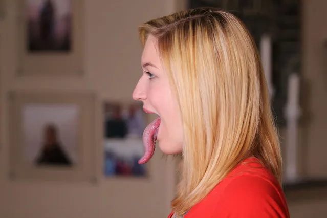 Adrianne Lewis sticking her tongue out, on April 4, 2015, in Twin Lake, Michigan.  Adrianne Lewis believes she has the world's longest tongue measuring a whopping 4 inches. The 18-year-old is now globally recognised after a photo of her sticking her tongue out went viral online. Her serpent-like appendage can touch her nose, chin, elbow, and even her eye with a little help. And she is currently in talks with Guinness World Records and waiting to see if she's the new record holder. (Photo by Bridgette Pacholka/Barcroft USA)