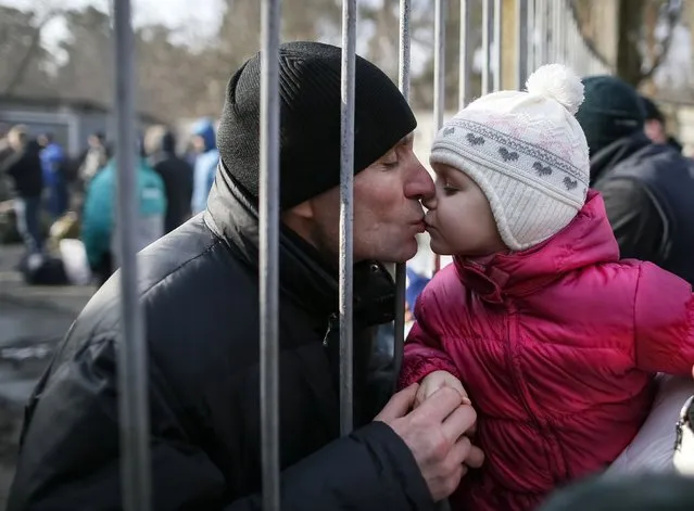 A girl kisses her father, a conscript, after a ceremony marking enrolment for new conscripts in the Ukrainian army in Kiev January 29, 2015. (Photo by Gleb Garanich/Reuters)