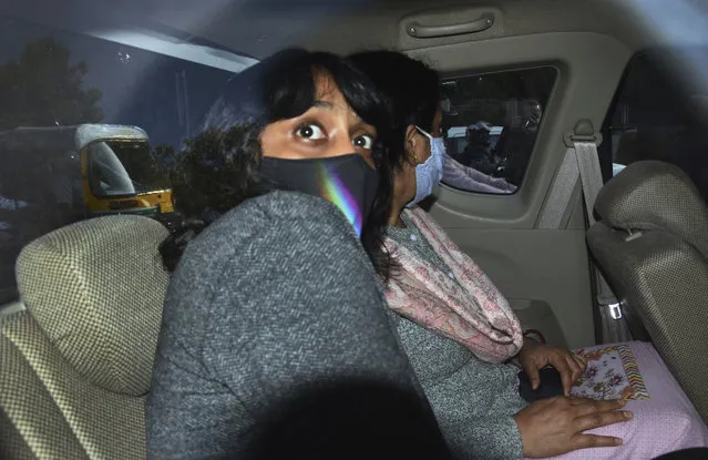 In this February 22, 2021, file photo, climate activist Disha Ravi, 22, travels in a car as she is taken to a court in New Delhi, India. To her friends, Ravi, was most concerned about her future in a world where temperatures are rising. But her life changed last month as she became a household name in the country, dominating news coverage after police charged her with sedition, a colonial-era law which carries a sentence up to life. Her alleged crime: sharing an online document to help amplify months-long farmer protests in India on Twitter. She was released after 10 days in custody. (Photo by Dinesh Joshi/AP Photo/File)