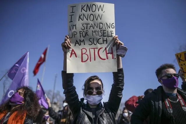 A protester holds a placard during a demonstration in Istanbul, Saturday, March 27, 2021, against Turkey's withdrawal from Istanbul Convention, an international accord designed to protect women from violence. (Photo by Emrah Gurel/AP Photo)