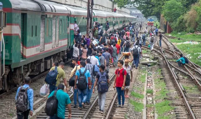 Bangladeshi people crowd a train as they prepare to travel to their villages ahead of Eid-al-Adha, at the Kamlapur Railway Station in Dhaka, Bangladesh, 26 June 2023. Eid al-Adha is the holiest of the two Muslims holidays celebrated each year, it marks the yearly Muslim pilgrimage (Hajj) to visit Mecca, the holiest place in Islam. Muslims slaughter a sacrificial animal and split the meat into three parts, one for the family, one for friends and relatives, and one for the poor and needy. (Photo by Monirul Alam/EPA/EFE/Rex Features/Shutterstock)