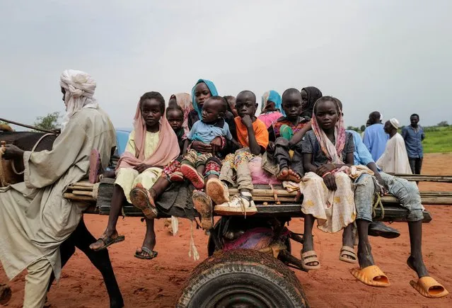 Sudanese children, who fled the conflict in Murnei in Sudan's Darfur region, ride a cart while crossing  the border between Sudan and Chad in Adre, Chad on August 4, 2023. (Photo by Zohra Bensemra/Reuters)