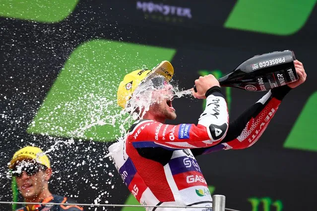 Kalex British rider Jake Dixon celebrates on the podium after winning the Moto2 race of the Moto Grand Prix de Catalunya at the Circuit de Catalunya in Montmelo, on the outskirts of Barcelona, on September 3, 2023. (Photo by Josep Lago/AFP Photo)
