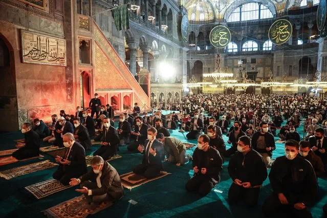 People gather to perform first Eid al-Fitr prayer after 87 years within precautions against the novel coronavirus (COVID-19) pandemic at the Hagia Sophia Grand Mosque in Istanbul, Turkey on May 13, 2021. (Photo by Ahmet Bolat/Anadolu Agency via Getty Images)