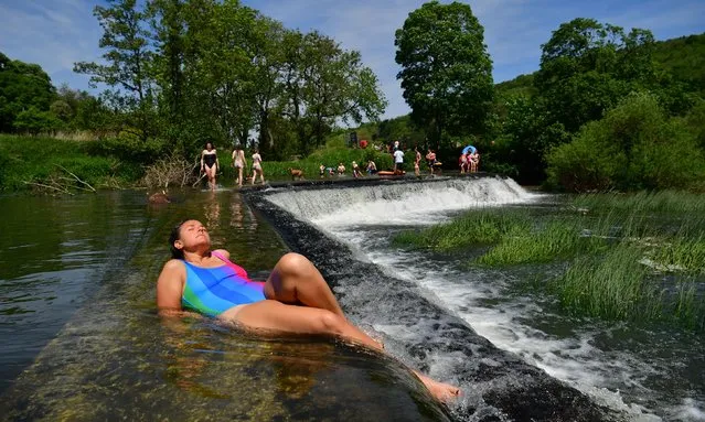 People sunbathe in the hot weather at Warleigh Weir, Bath, United Kingdom on the first day of meteorological summer on Tuesday, June 1, 2021. (Photo by Ben Birchall/PA Images via Getty Images)