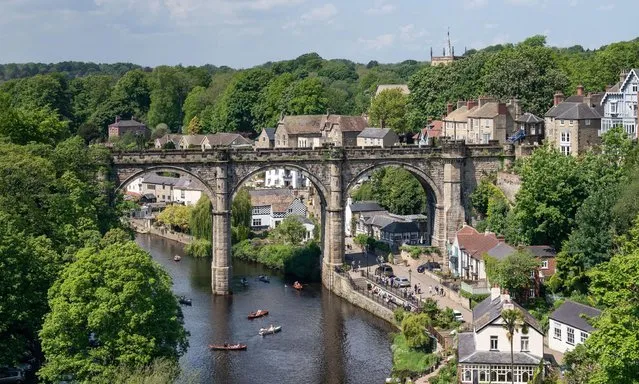 People row boats underneath the Knaresborough Viaduct on River Nidd in North Yorkshire on Saturday, May 29, 2021, as they enjoy the summer weather over the bank holiday weekend which is expected to bring blue skies and widespread sunshine. (Photo by Danny Lawson/PA Images via Getty Images)