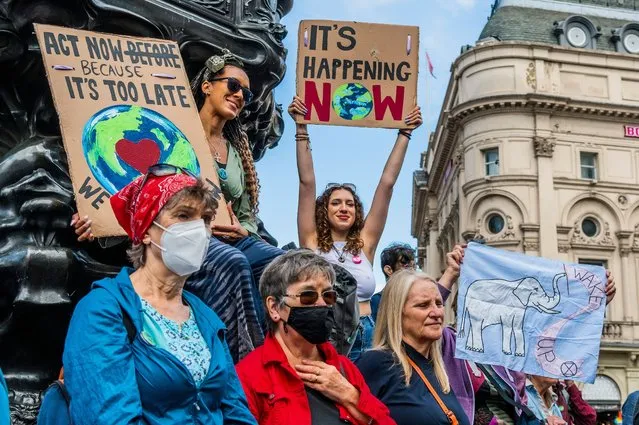 Women gather at Piccadilly Circus in a “Courage calls to Courage” protest in London, United Kingdom on August 25, 2021. Led by Female, Intersеx, Non-binary and Trans (FINT) people from Extinction Rebellion, rebels demand that government change policies to address the ecological and climate emergency and immediately stop all new fossil fuel investments. (Photo by Guy Bell/Rex Features/Shutterstock)