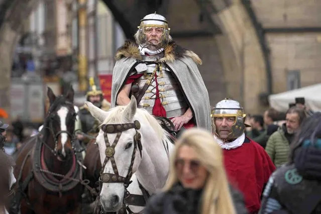 A man wearing a replica of a Roman empire era military outfit, depicting Saint Martin riding a horse, on Charles Bridge in Prague, Czech Republic, Friday, November 11, 2022. Saint Martin's Day marks the end of the harvest season as well as the start of winter. (Photo by Vadim Ghirda/AP Photo)