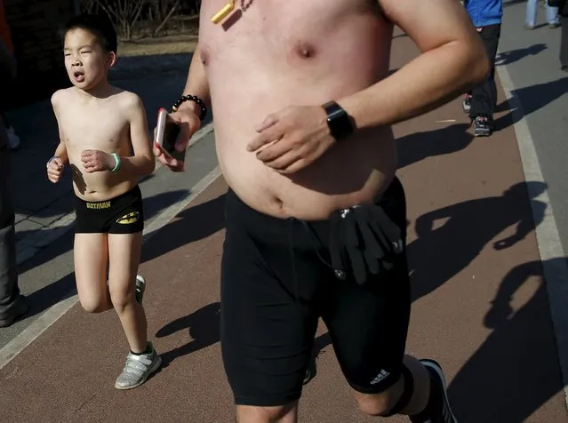 A boy runs at the “Half-Naked Marathon” at Olympic Forest park in Beijing, China, February 28, 2016 (Photo by Kim Kyung-Hoon/Reuters)