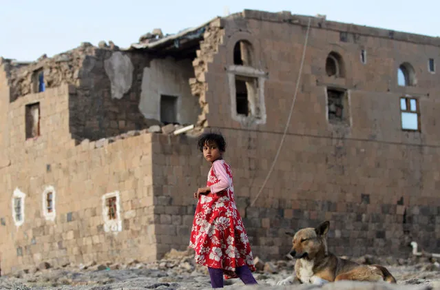A girl walks near her house destroyed in an air strike carried out by the Saudi-led coalition in Faj Attan village, Sanaa, Yemen December 13, 2018. (Photo by Mohamed al-Sayaghi/Reuters)