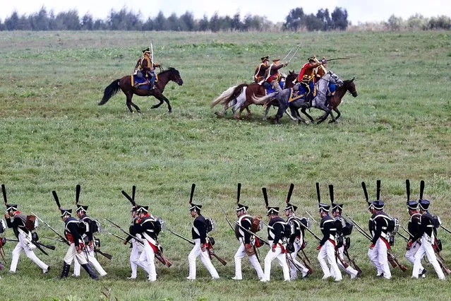 Performers wearing period uniforms take part in a reenactment of the Battle of Borodino to mark the 209th anniversary of the battle during the Day of Borodino international military historical festival in Moscow Region, Russia on September 5, 2021. (Photo by Stanislav Krasilnikov/TASS)