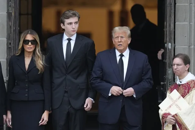 Former President Donald Trump, center right, stands with his wife Melania, left, and their son Barron, center left, outside the Church of Bethesda-by-the-Sea at the start of a funeral for Amalija Knavs, the former first lady's mother, in Palm Beach, Fla., Thursday, January 18, 2024. (Photo by Rebecca Blackwell/AP Photo)