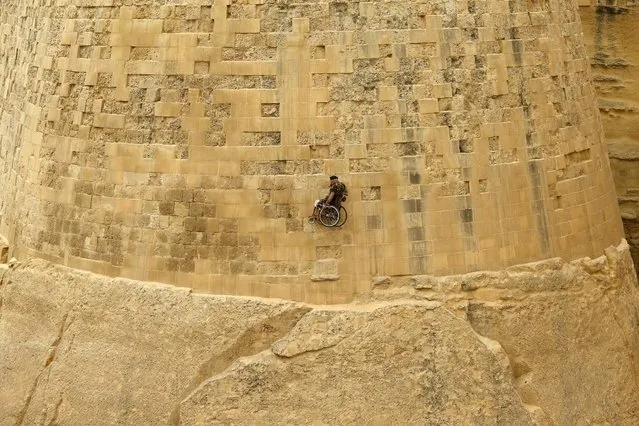 British former police officer Swasie Turner abseils for charity in a wheelchair down the fortification bastions of Valletta, Malta, April 27, 2015. Turner has wheeled himself more than 38,000 miles and raised over £1 million for charity since 1997 after losing his wife to cancer, according to local media. The traumatic loss came months after he was confined to a wheelchair when he was deliberately run down by a motorcycle while on duty as a police officer. (Photo by Darrin Zammit Lupi/Reuters)