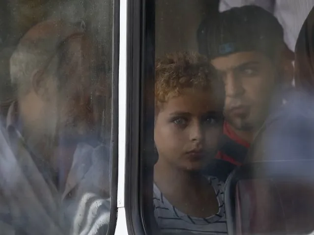 Syrian immigrant Mohamed, 12, looks out of the window of a police bus after arriving at the Armed Forces of Malta Maritime Squadron base at Haywharf in Valletta's Marsamxett Harbour in this October 12, 2013 file photo. (Photo by Darrin Zammit Lupi/Reuters)