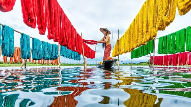 Dyed cotton is hung out to dry in a floating village on Inle Lake, Myanmar, one of many settlements on stilts that sit between two mountain ranges in August 2021. (Photo by Sarah Wouters/Solent News)
