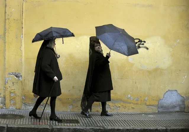 Penitents walk after the governing body of the “Estudiantes” brotherhood decided that penance could not be carried out in the streets due to rain on Palm Sunday in Oviedo, northern Spain, March 20, 2016. (Photo by Eloy Alonso/Reuters)