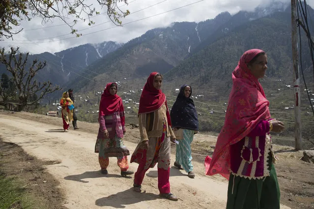 Kashmiri women walk back from a polling station during the second phase of India's general elections, in Baba Nagri, about 44 kilometers (28 miles) northeast of Srinagar, Indian controlled Kashmir, Thursday, April 18, 2019. Kashmiri separatist leaders who challenge India's sovereignty over the disputed region have called for a boycott of the vote. Most polling stations in Srinagar and Budgam areas of Kashmir looked deserted in the morning with more armed police, paramilitary soldiers and election staff present than voters. (Photo by Dar Yasin/AP Photo)