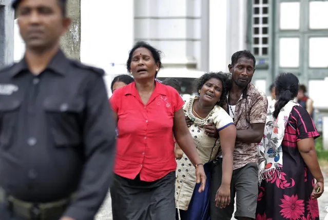 Relatives of a blast victim grieve outside a morgue in Colombo, Sri Lanka, Sunday, April 21, 2019.  More than hundred were killed and hundreds more hospitalized with injuries from eight blasts that rocked churches and hotels in and just outside of Sri Lanka's capital on Easter Sunday, officials said, the worst violence to hit the South Asian country since its civil war ended a decade ago. (Photo by Eranga Jayawardena/AP Photo)